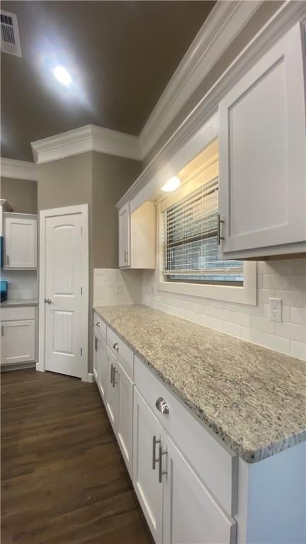 1912 Hale Ln, Pea Ridge, AR 72751 - kitchen featuring ornamental molding, decorative backsplash, dark wood-type flooring, light stone countertops, and white cabinets
