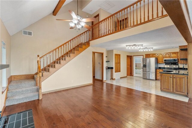 18322 Oakridge Rd, Springdale, AR 72764 - unfurnished living room with ceiling fan, light wood-style flooring, stairs, beamed ceiling, and baseboards