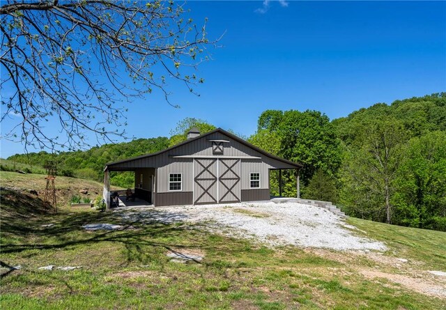 14210 Lake Point Dr, Lowell, AR 72745 - view of barn with a view of trees