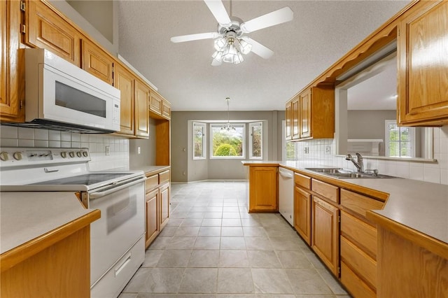 12 Luncarty Ln, Bella Vista, AR 72715 - kitchen featuring white appliances, tasteful backsplash, healthy amount of natural light, light countertops, and a textured ceiling