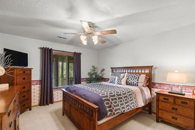 16180 Black Oak Ln, Rogers, AR 72756 - bedroom featuring light carpet, a ceiling fan, a textured ceiling, and a wainscoted wall