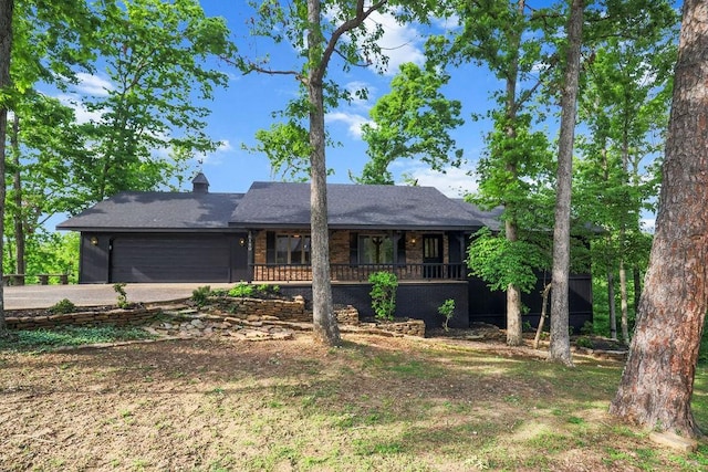 16180 Black Oak Ln, Rogers, AR 72756 - ranch-style home with an attached garage, driveway, covered porch, and a chimney