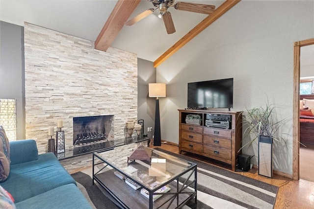 16180 Black Oak Ln, Rogers, AR 72756 - living area featuring wood finished floors, ceiling fan, beam ceiling, a stone fireplace, and high vaulted ceiling