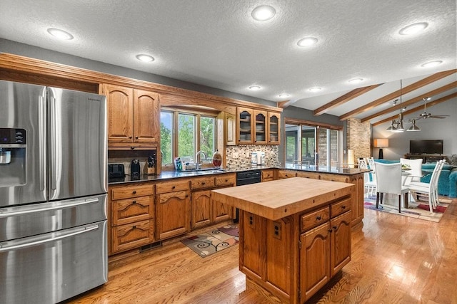 16180 Black Oak Ln, Rogers, AR 72756 - kitchen featuring stainless steel refrigerator with ice dispenser, butcher block counters, a textured ceiling, a sink, and brown cabinetry