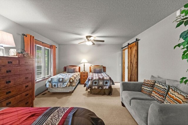 16180 Black Oak Ln, Rogers, AR 72756 - carpeted bedroom featuring a barn door, a textured ceiling, and a ceiling fan