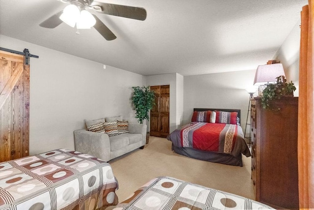 16180 Black Oak Ln, Rogers, AR 72756 - bedroom featuring a barn door, carpet, and a ceiling fan