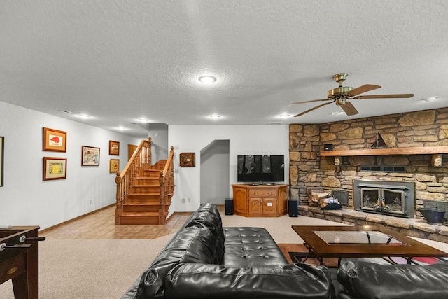 16180 Black Oak Ln, Rogers, AR 72756 - living area with ceiling fan, baseboards, a textured ceiling, light colored carpet, and stairs