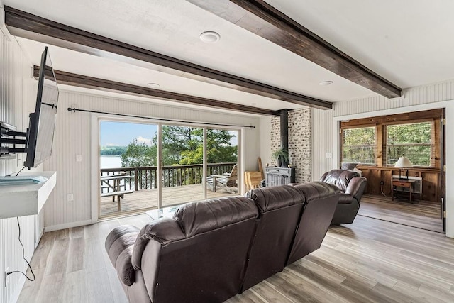 9211 Larue Rd, Rogers, AR 72756 - living area featuring a wood stove, beamed ceiling, light wood-type flooring, baseboards, and wood walls
