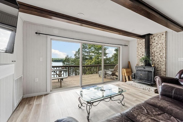 9211 Larue Rd, Rogers, AR 72756 - living room featuring a wood stove, wood finished floors, beamed ceiling, and a water view