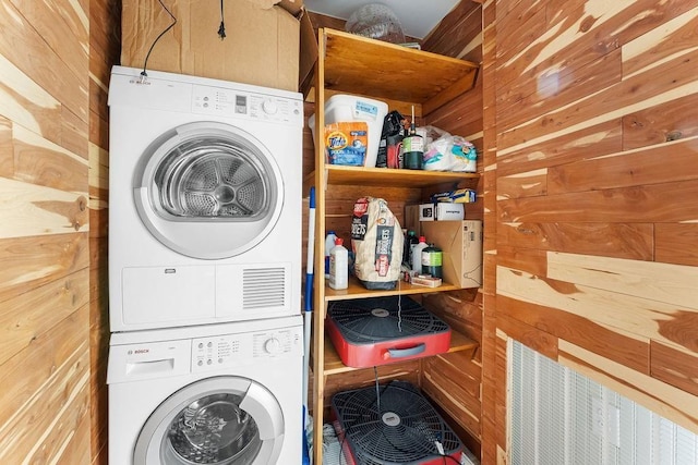 9211 Larue Rd, Rogers, AR 72756 - laundry area featuring stacked washer / drying machine and wooden walls