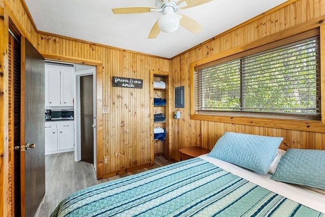 9211 Larue Rd, Rogers, AR 72756 - bedroom with wooden walls, wood finished floors, and crown molding