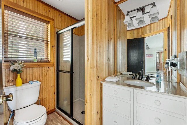 9211 Larue Rd, Rogers, AR 72756 - full bathroom with wood walls, a shower stall, toilet, vanity, and wood finished floors