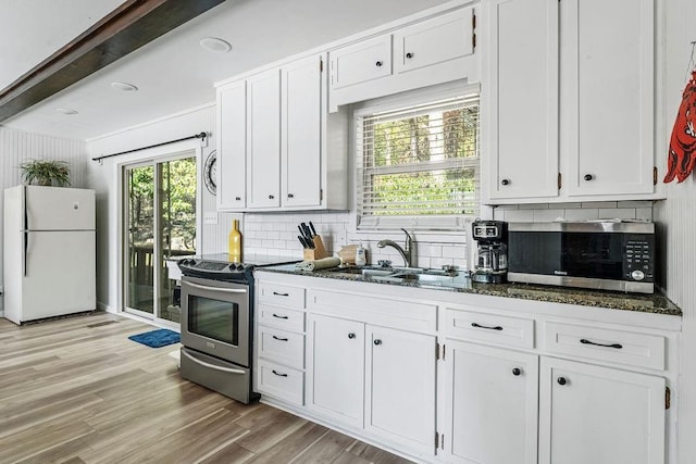 9211 Larue Rd, Rogers, AR 72756 - kitchen with stainless steel appliances, a sink, tasteful backsplash, white cabinets, and light wood-style flooring
