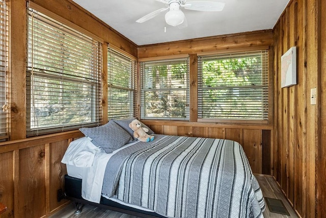 9211 Larue Rd, Rogers, AR 72756 - bedroom with wood walls, a ceiling fan, and wood finished floors