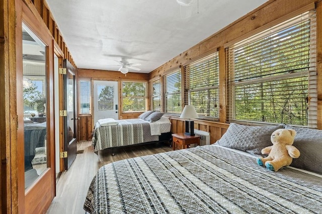 9211 Larue Rd, Rogers, AR 72756 - bedroom featuring wood finished floors, a ceiling fan, and wood walls