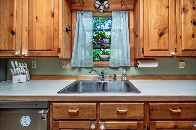 398 Northfork Dr, Berryville, AR 72616 - kitchen with dishwasher, a sink, tile counters, and brown cabinets