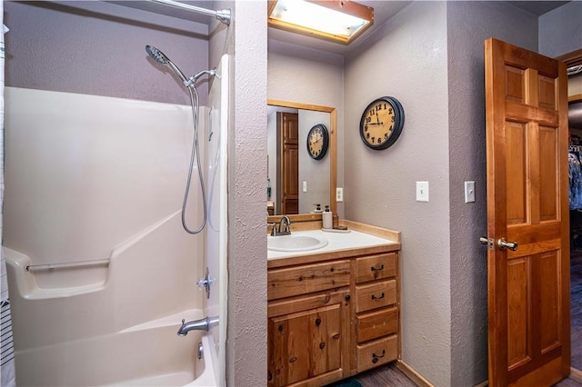 398 Northfork Dr, Berryville, AR 72616 - full bathroom featuring a textured wall, tub / shower combination, vanity, and wood finished floors