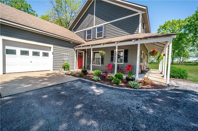 398 Northfork Dr, Berryville, AR 72616 - view of front of house featuring driveway, covered porch, a garage, and roof with shingles