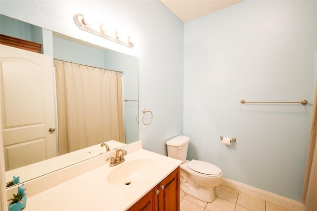 bathroom with tile patterned floors, toilet, baseboards, vanity, and curtained shower