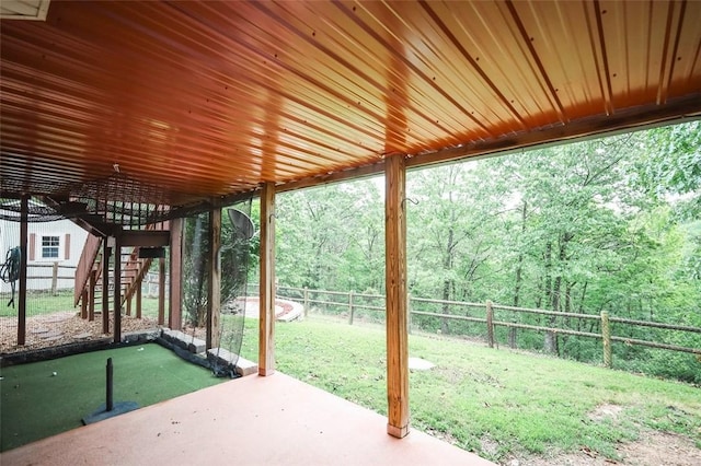 view of patio with stairs and a forest view