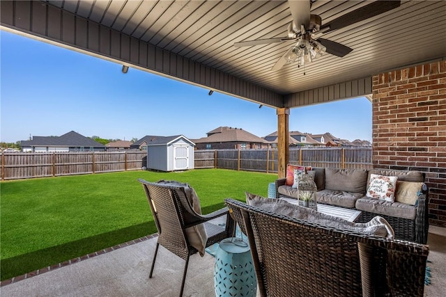 view of patio with a ceiling fan, an outdoor living space, a storage unit, an outbuilding, and a residential view