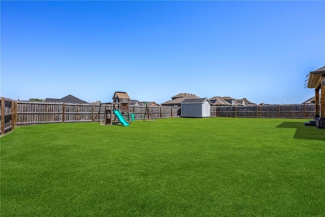 view of yard with a playground, a storage shed, and an outdoor structure