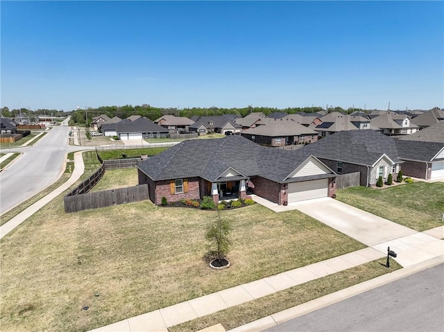 view of front facade featuring a residential view, brick siding, driveway, a garage, and a shingled roof
