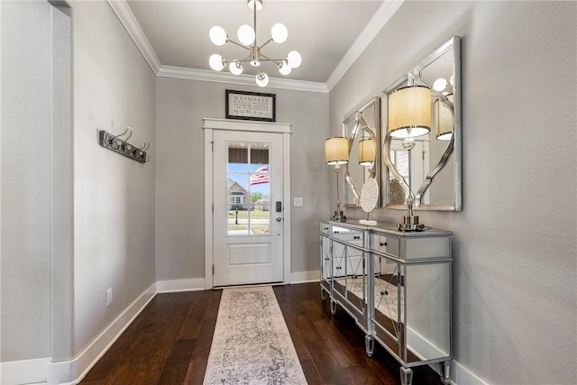entrance foyer with a chandelier, dark wood-type flooring, crown molding, and baseboards