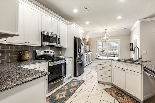 kitchen with stainless steel appliances, a sink, a chandelier, white cabinetry, and decorative backsplash