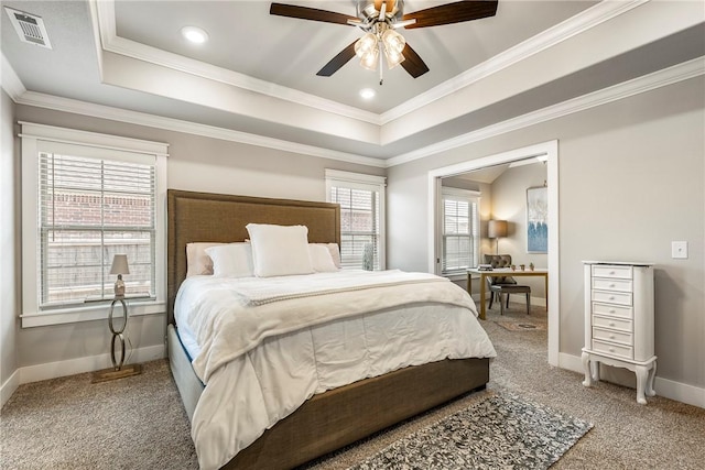 bedroom with carpet, a raised ceiling, baseboards, and crown molding