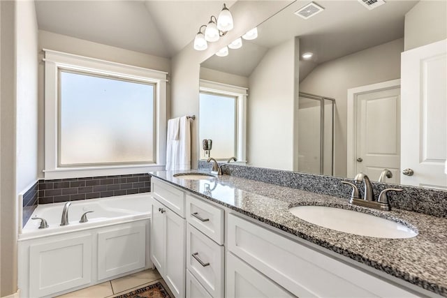 full bathroom featuring lofted ceiling, tile patterned floors, a stall shower, a bath, and double vanity