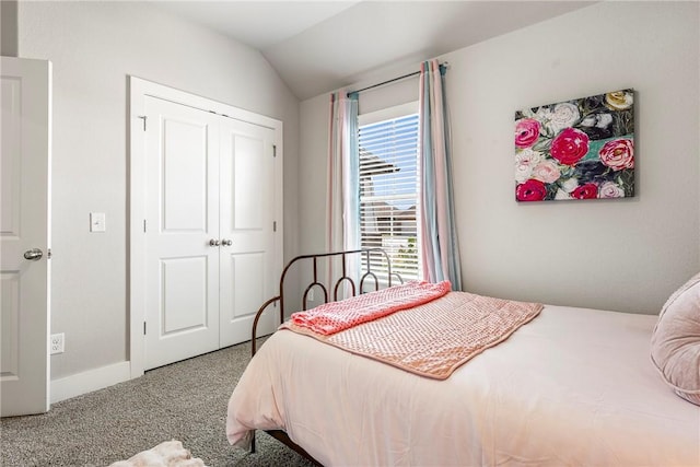 carpeted bedroom featuring vaulted ceiling, a closet, and baseboards
