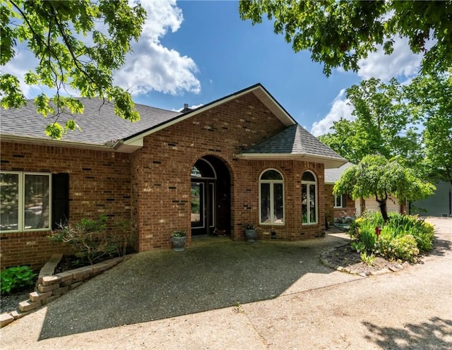30 Brittany Ln, Bella Vista, AR 72714 - view of front of house featuring brick siding and a shingled roof