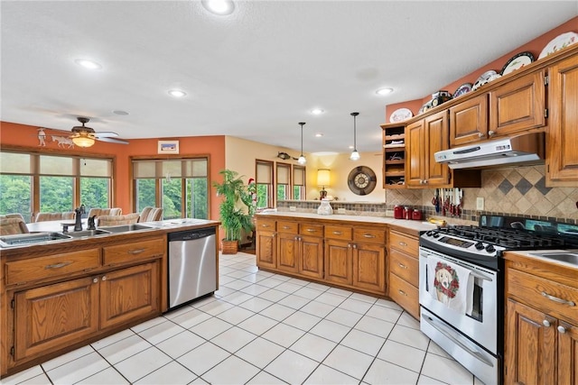 30 Brittany Ln, Bella Vista, AR 72714 - kitchen with appliances with stainless steel finishes, under cabinet range hood, brown cabinetry, a peninsula, and recessed lighting