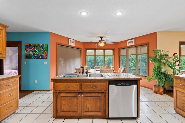30 Brittany Ln, Bella Vista, AR 72714 - kitchen with dishwasher, a sink, tile counters, baseboards, and ceiling fan