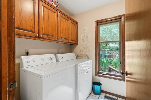 30 Brittany Ln, Bella Vista, AR 72714 - laundry room featuring cabinet space, washing machine and clothes dryer, plenty of natural light, and light tile patterned flooring