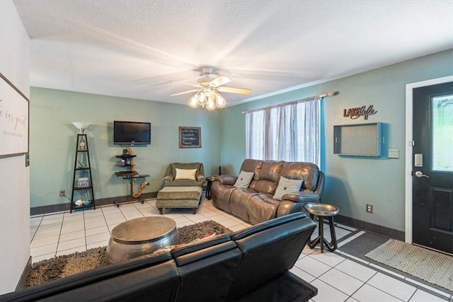 22058 Dogwood Cir, Springdale, AR 72764 - living room with light tile patterned flooring, ceiling fan, baseboards, and a textured ceiling