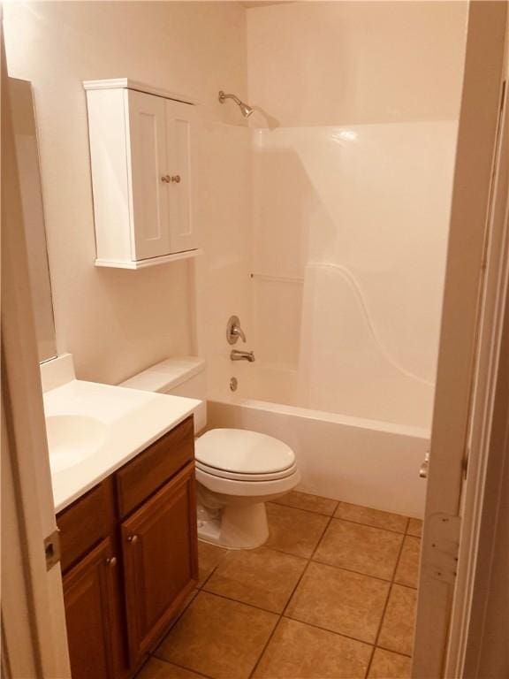 bathroom with vanity, toilet, tile patterned floors, and  shower combination