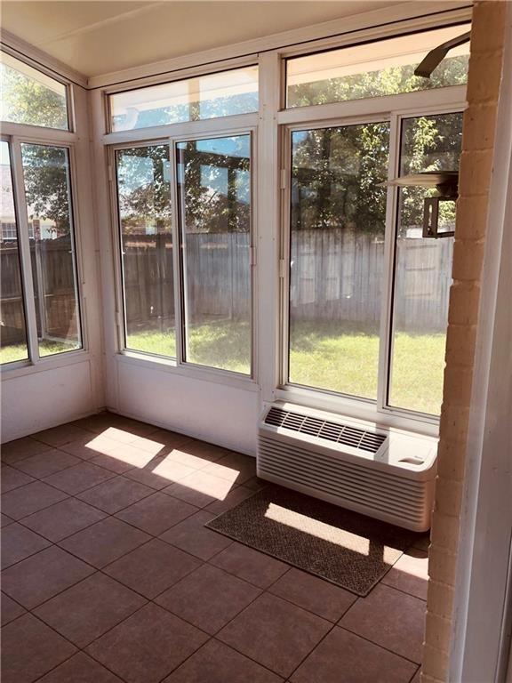unfurnished sunroom with healthy amount of natural light