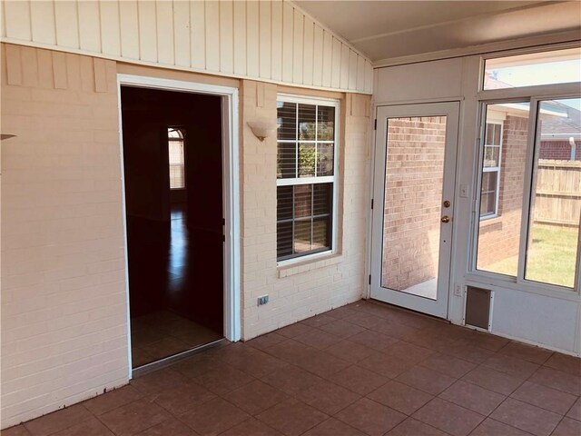 unfurnished sunroom with plenty of natural light