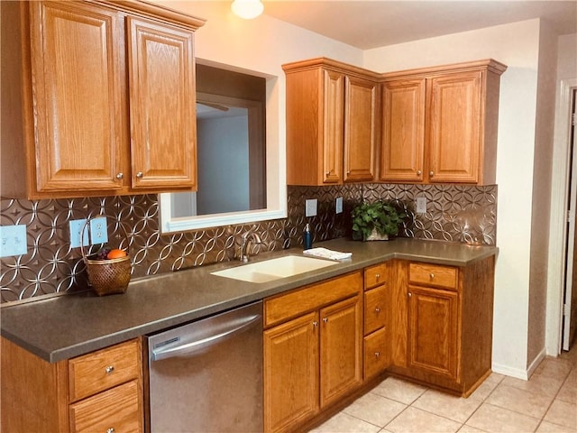kitchen featuring dishwasher, a sink, light tile patterned floors, and decorative backsplash