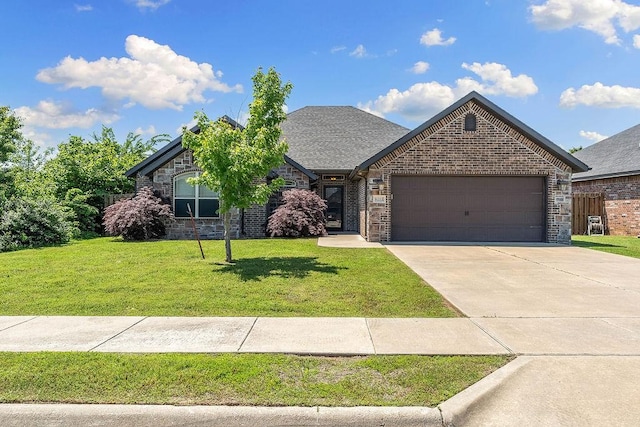 view of front of property featuring a garage, a front yard, brick siding, concrete driveway, and a shingled roof