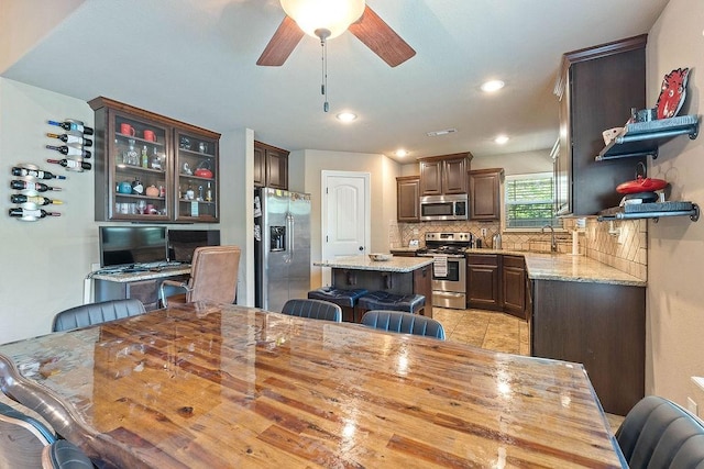 dining space with ceiling fan, light tile patterned flooring, and recessed lighting