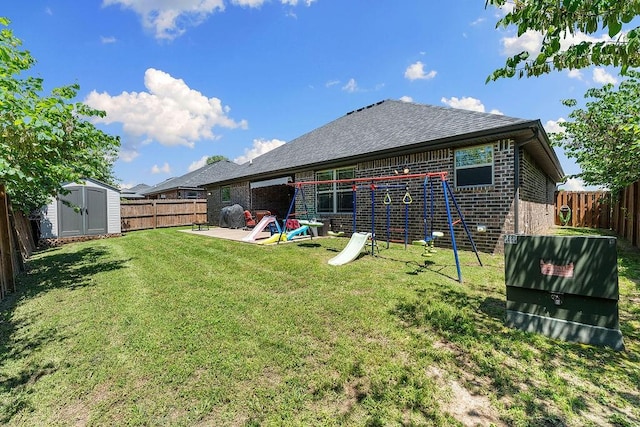 back of property featuring brick siding, a storage shed, an outdoor structure, a playground, and a patio area