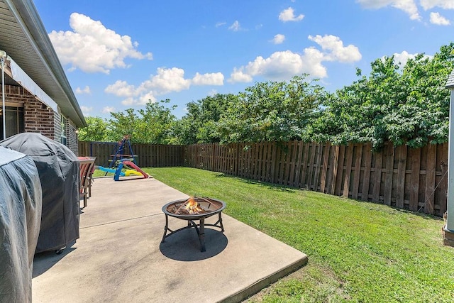 view of yard featuring an outdoor fire pit and a patio