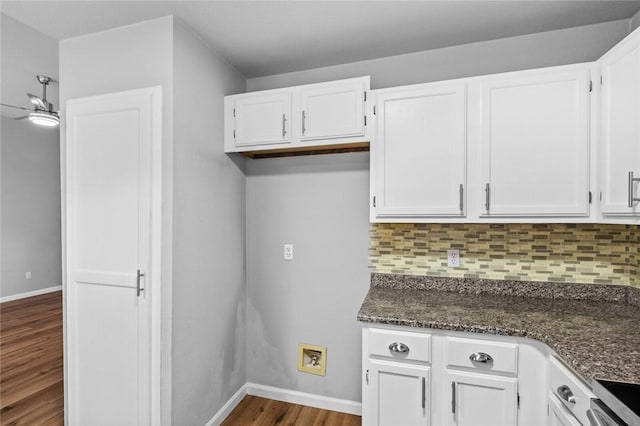 kitchen with white cabinetry, dark wood-style floors, and decorative backsplash