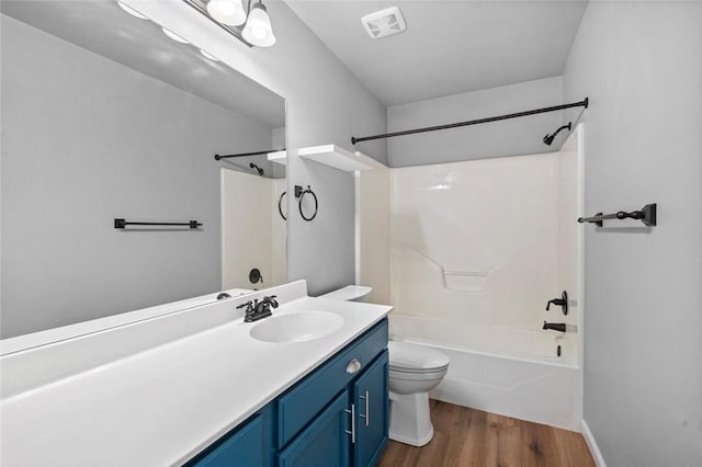 full bath with wood finished floors, toilet, shower / tub combination, and vanity