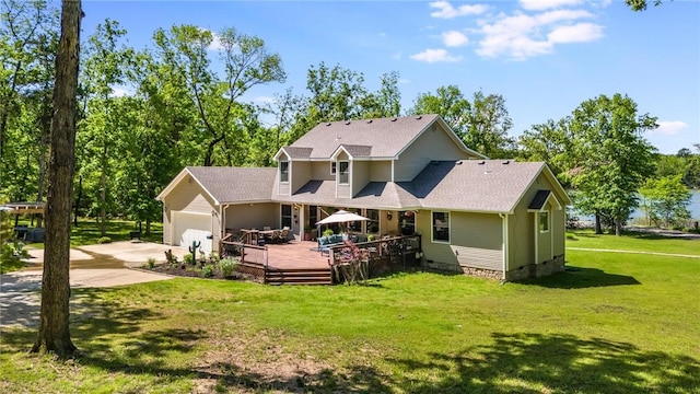 9696 Fuller Rd, Rogers, AR 72756 - rear view of house featuring concrete driveway, an attached garage, a lawn, a deck, and roof with shingles