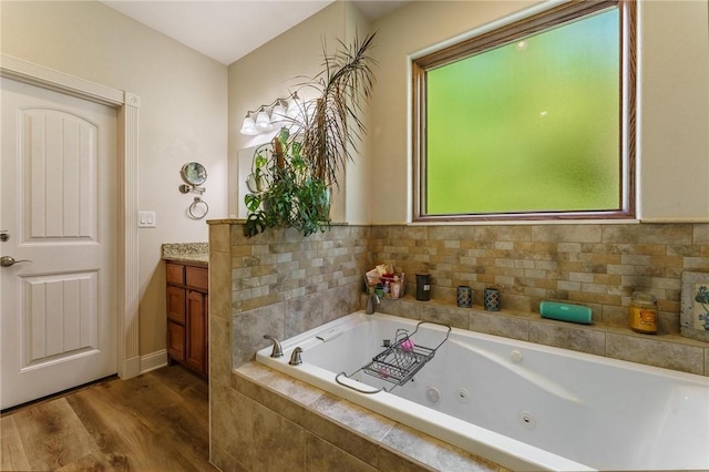 9696 Fuller Rd, Rogers, AR 72756 - bathroom featuring wood finished floors, a whirlpool tub, and vanity
