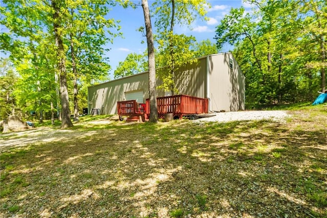 9696 Fuller Rd, Rogers, AR 72756 - view of yard with a wooden deck and a detached garage